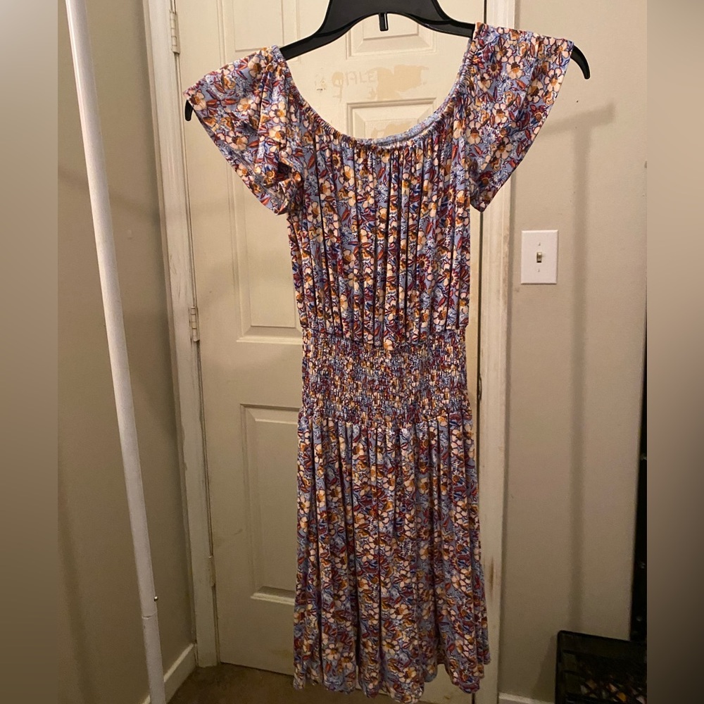 Floral dress with flowers all over and a string tie around the waist